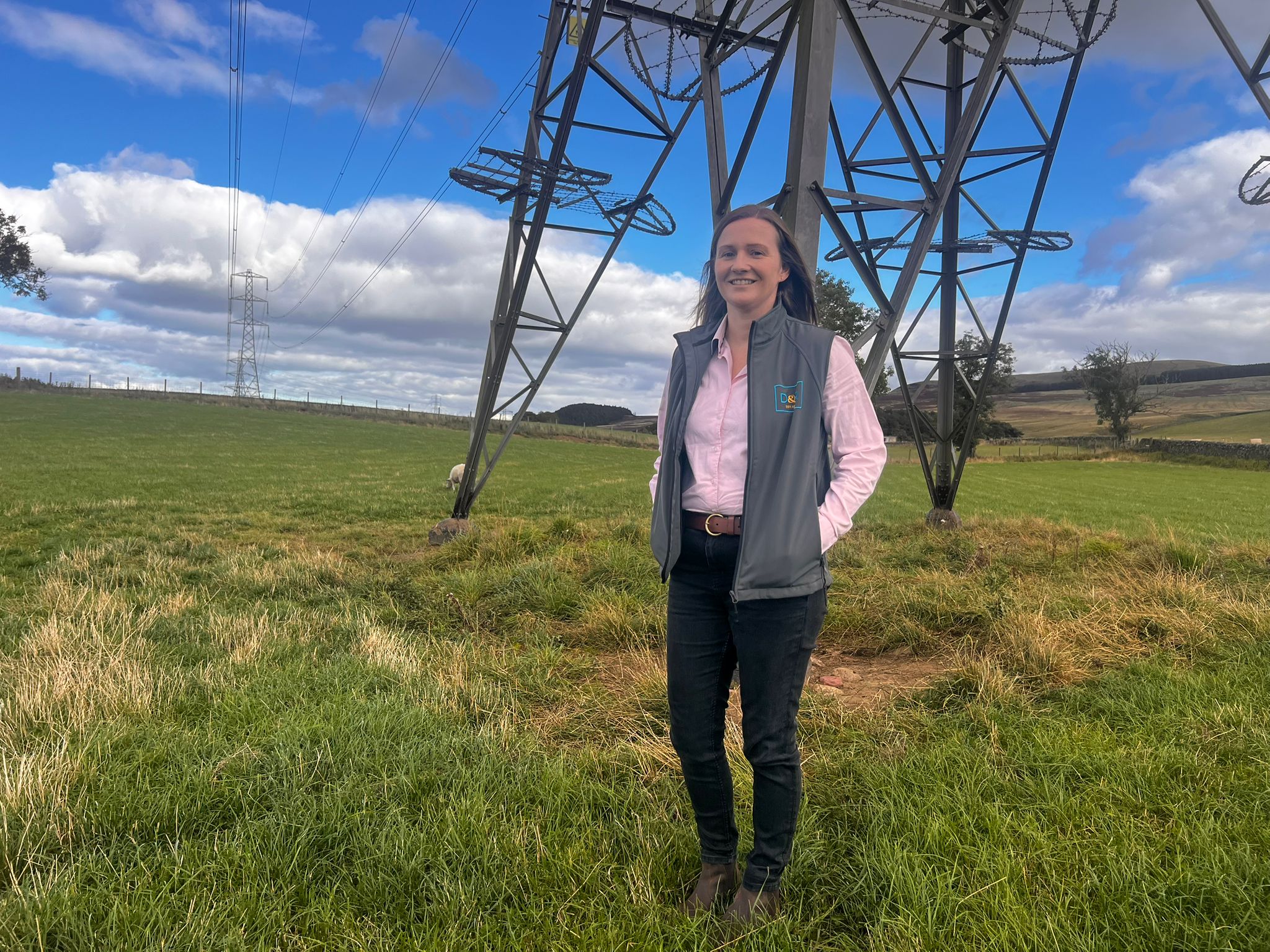 Kerry Clark Senior Land Agent at Davidson & Robertson by a pylon